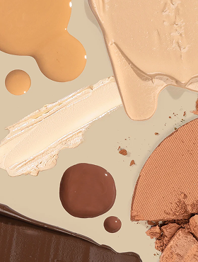Makeup swatches and smears in beige, tan, and brown: cream foundation smear, liquid drops, and crushed powder.