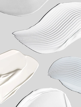 Abstract swatches of white and pale beige cream textures on a light gray background